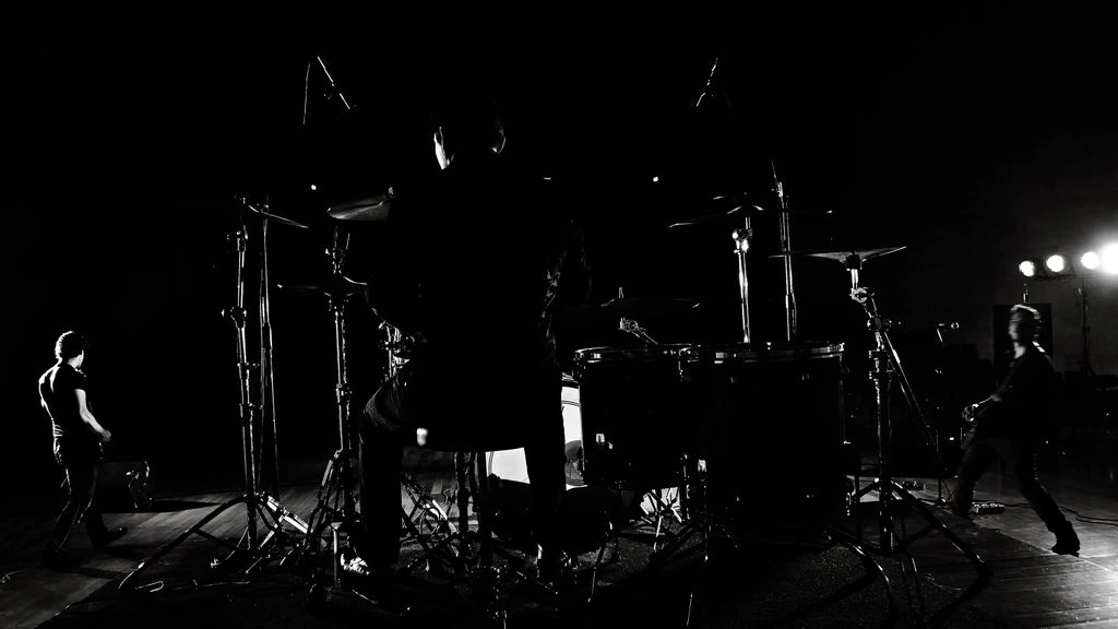 Empty rock venue stage lit by colored spotlights before a show